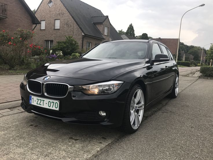 a black car is parked on the street