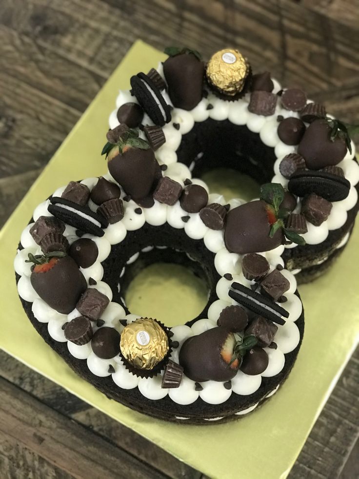 two chocolate covered donuts sitting on top of a green plate