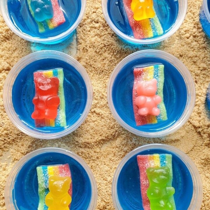 six plastic plates with gummy bears on them in the shape of rainbows and ice cream