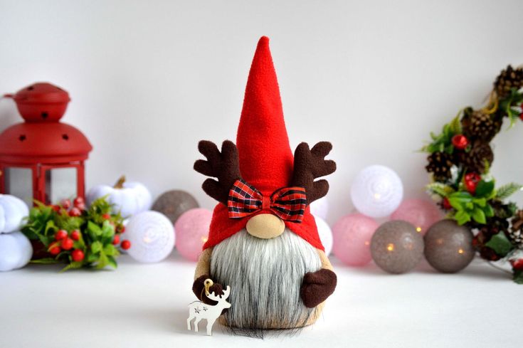 a small gnome with a deer figurine next to it