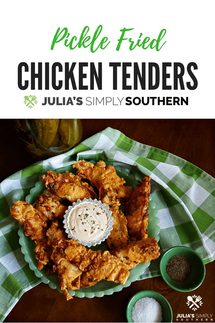 chicken tenders on a green and white checkered cloth with dipping sauce in the middle