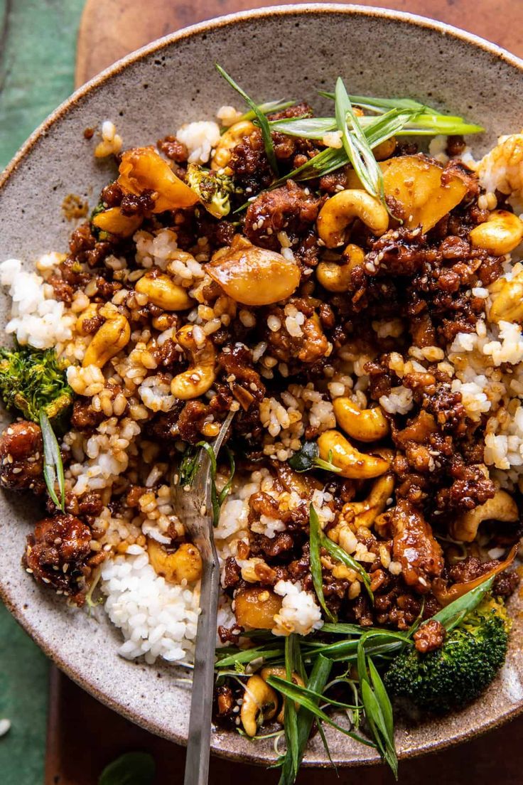 a bowl filled with rice, meat and vegetables