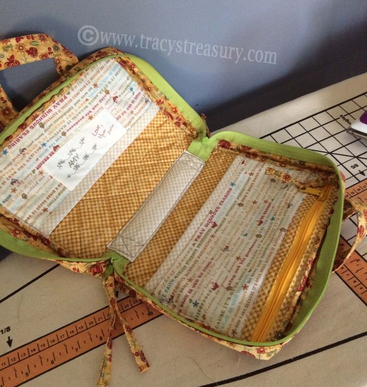 an open suitcase sitting on top of a table next to a measuring tape and scissors