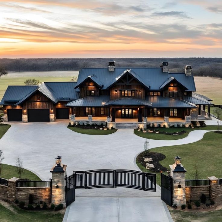 an aerial view of a large home at sunset