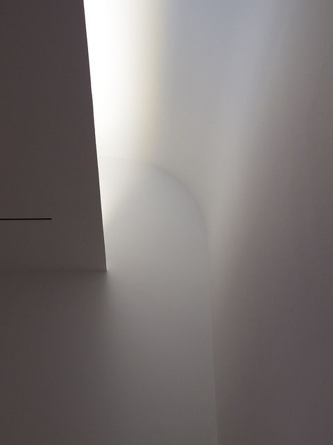 the light is shining through the window on the wall in the room that's white