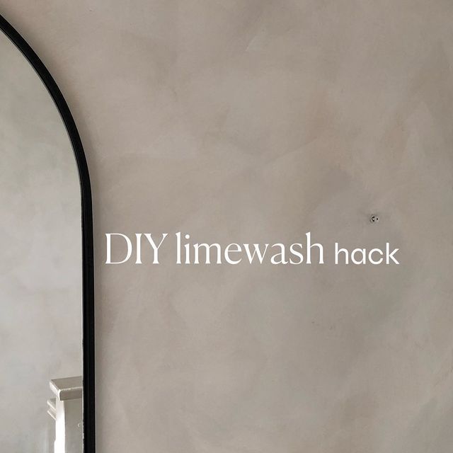 the words diy limewash hack are written in white on a gray wall next to a mirror