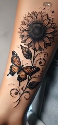 a sunflower and butterfly tattoo on the leg