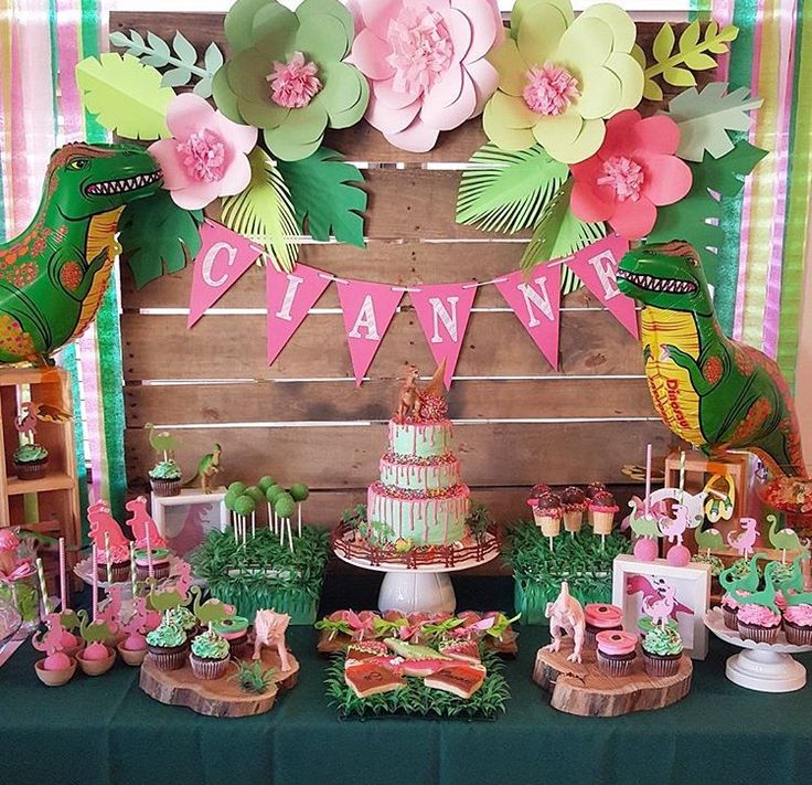 a table topped with cakes and desserts covered in paper flowers