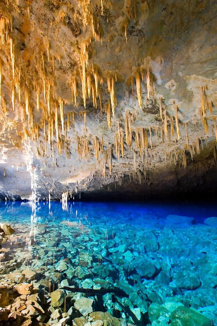 the water is crystal clear and blue in this cave