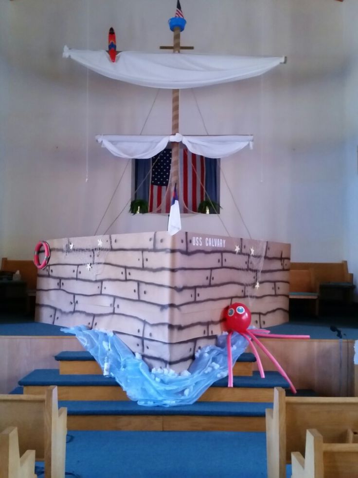 an image of a boat made out of bricks in a church with blue pews