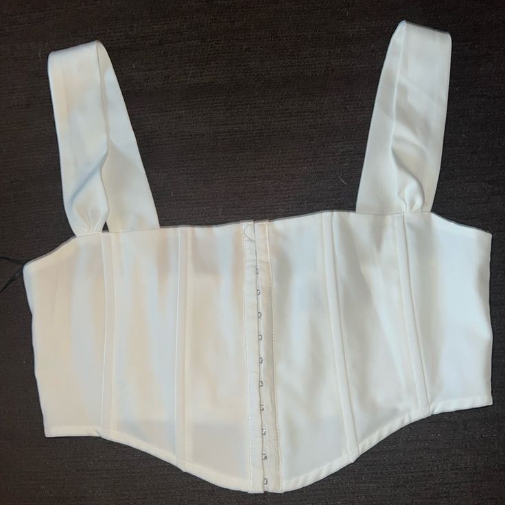 Listen Carefully White Bustier Top Chic White Bandage Corset, Chic Summer Corset With Hook And Eye Closure, Elegant White Crop Top With Adjustable Straps, Chic White Corset With Straps, White Crop Top With Corset Back For Party, White Tank Strap Crop Top For Parties, Elegant Cropped Corset With Boned Bodice, White Crop Top With Tank Straps For Party, Elegant Fitted Bandage Crop Top