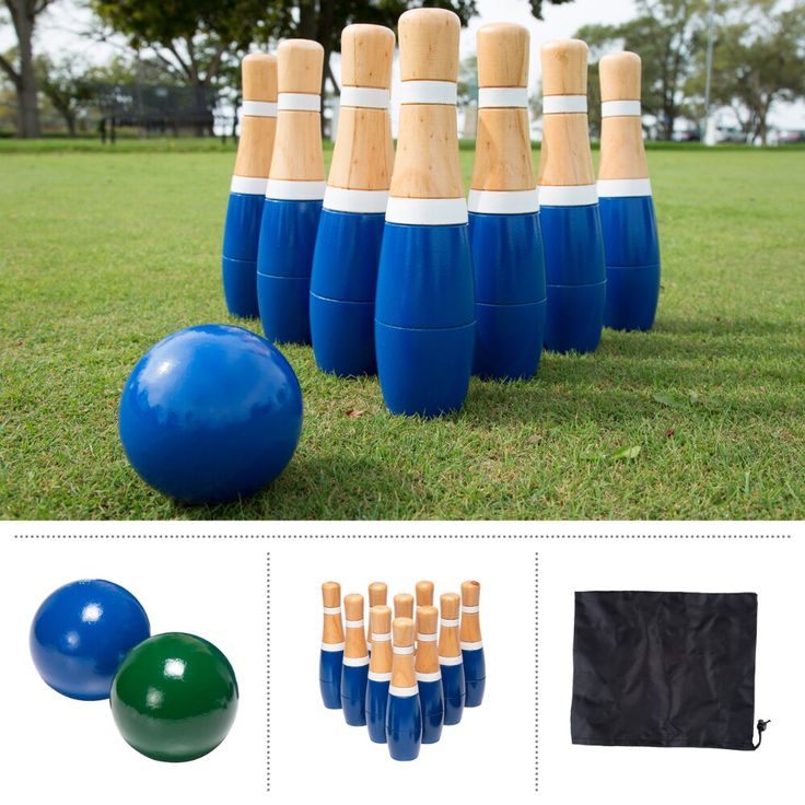 a bunch of blue and white plastic bowling balls next to some wooden poles in the grass