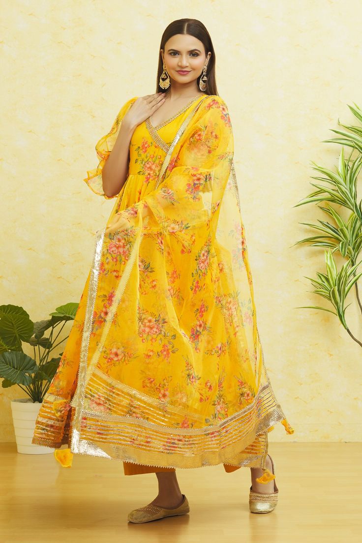 Saffron yellow floral print anarkali with balloon sleeves and side tie-up. Paired with a matching pant and dupatta.
Components: 3
Pattern: Embroidered
Type Of Work: Gota
Neckline: V Neck
Sleeve Type: Balloon
Fabric: Organza
Color: Yellow
Other Details: 
Balloon sleeves
Side tie-up
Closure: 
Pant: Front drawstring tie-up

Occasion: Mehendi and Haldi - Aza Fashions Floral Print Anarkali, Saffron Yellow, Fashion App, Balloon Sleeves, Set For Women, Yellow Floral, Anarkali, Aza Fashion, Sleeve Type