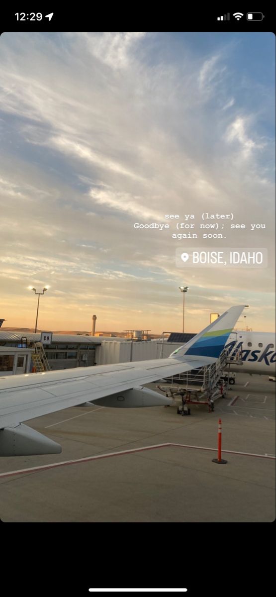 an airplane is parked on the tarmac at sunset