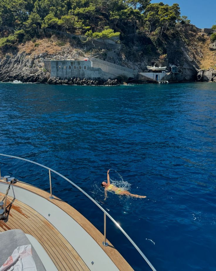 a person swimming in the water on a boat