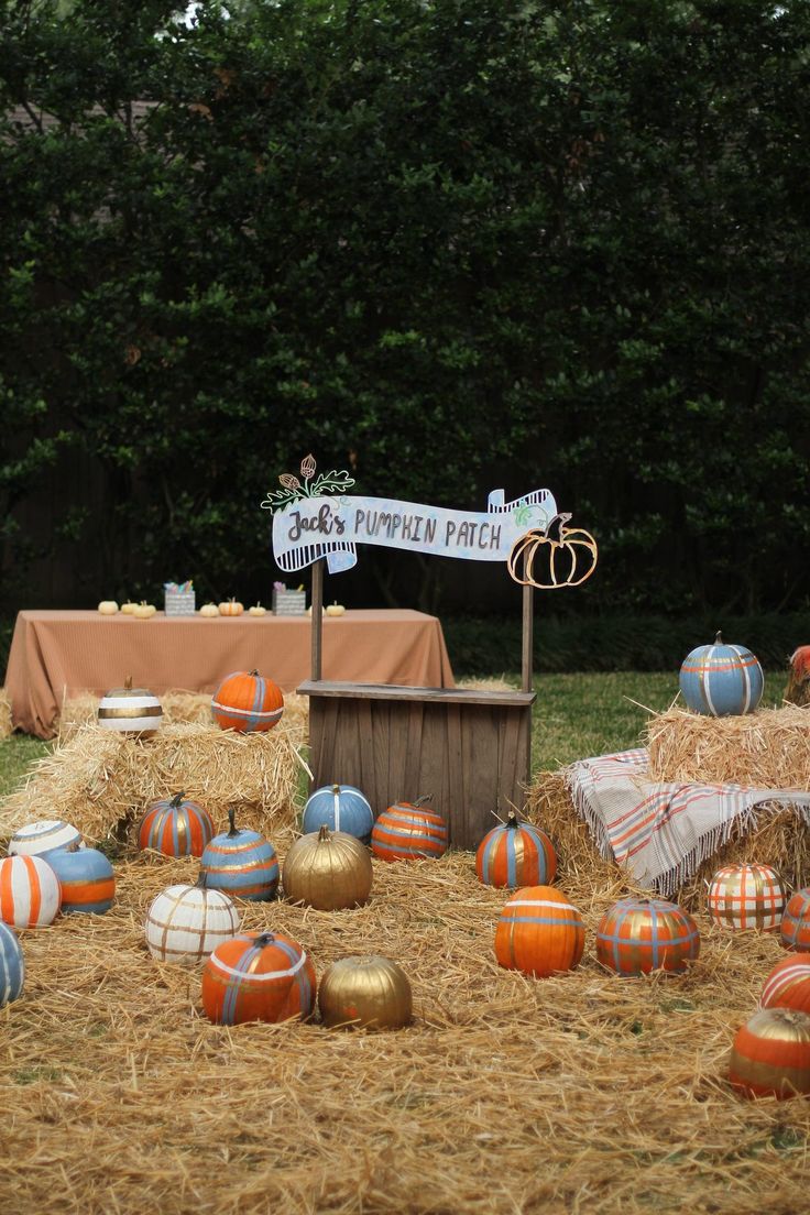 pumpkin patch display with hay bales and signs