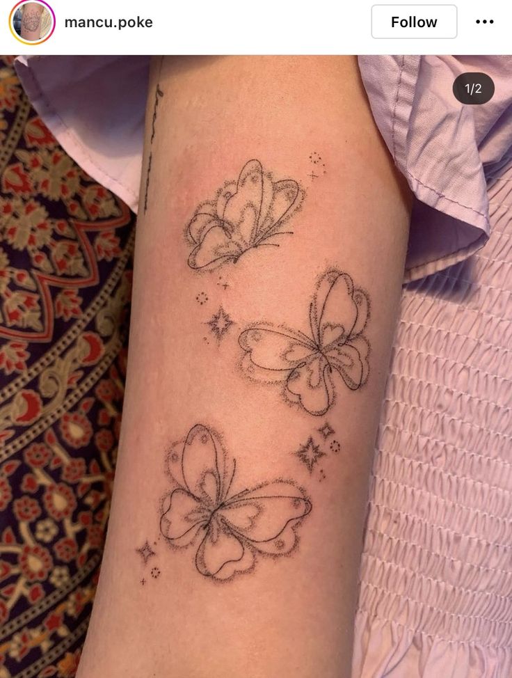 a woman's arm with three butterflies on it