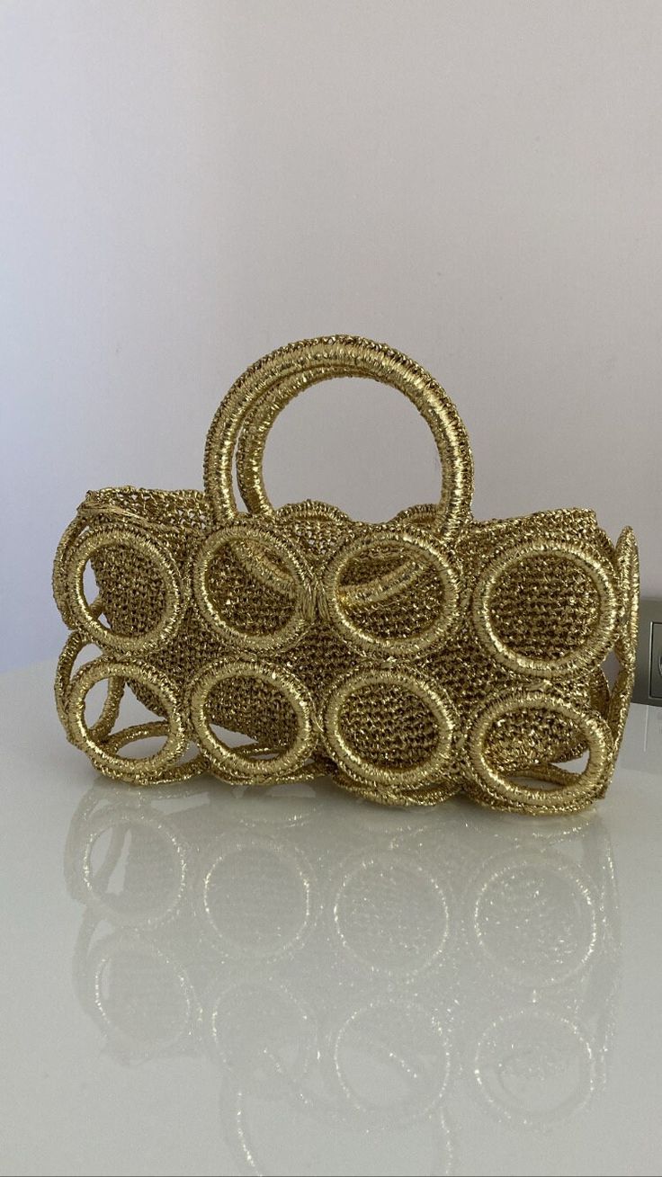 Made of;   metallic gold paper rope 28cm width  15cm hight  13cm diameter holders on sides Compatible with any kind of usage Can be cleaned only with dry cleaning, cleanings other than dry cleaning might cause discolouration. Fashionable handmade purse for your style.  Can be cleaned only with dry cleaning, cleanings other than dry cleaning might cause discolouration. Elegant Gold Straw Bag With Gold-tone Hardware, Luxury Gold Straw Bag With Braided Handles, Chic Gold Straw Bag With Braided Handles, Chic Gold Straw Bag For Evening, Luxury Gold Straw Bag, Chic Gold Straw Evening Bag, Chic Gold Rectangular Straw Bag, Gold Straw Bag With Gold-tone Hardware For Everyday, Gold Straw Bag For Party