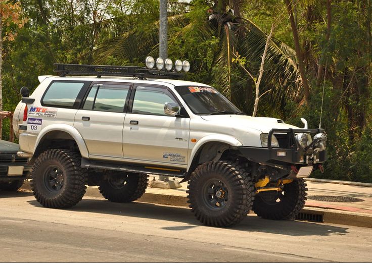 an off road vehicle is parked on the side of the street