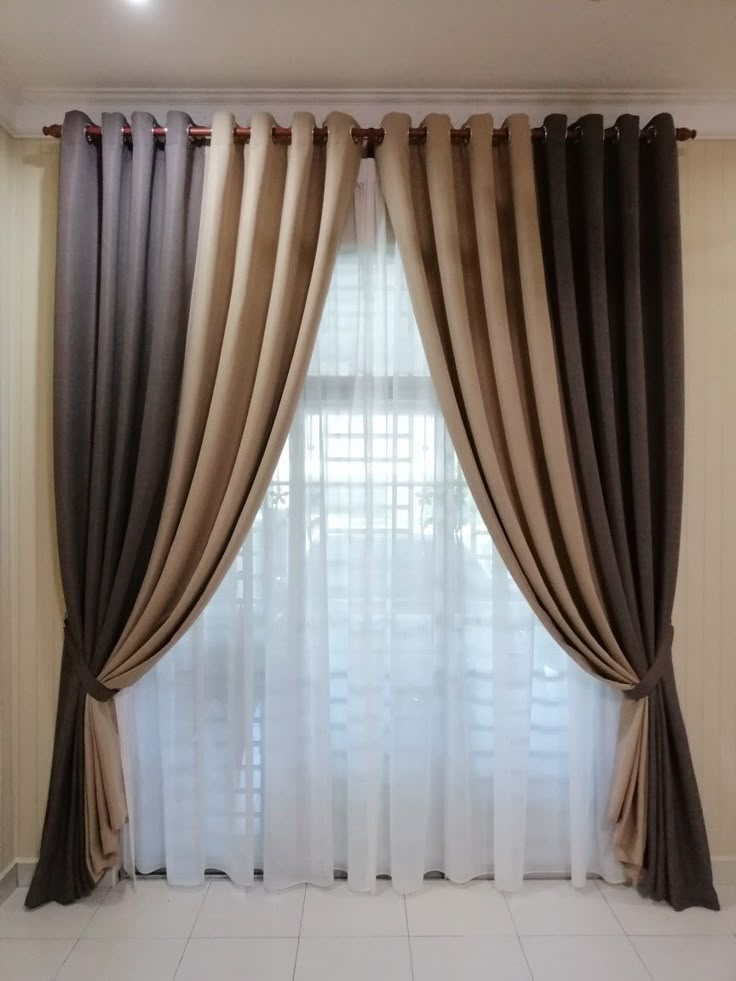 a living room with white tile flooring and curtains