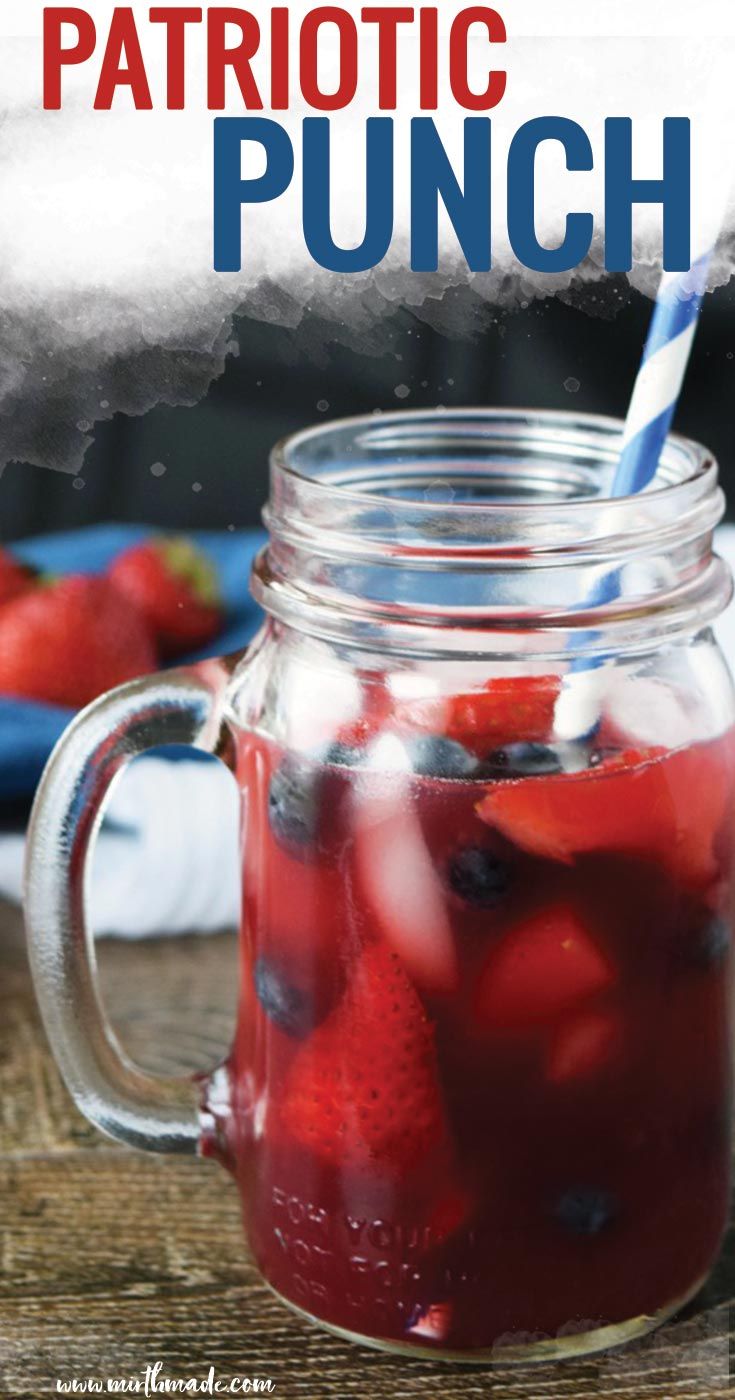 a mason jar filled with liquid and strawberries on top of a wooden table next to a plate of strawberries