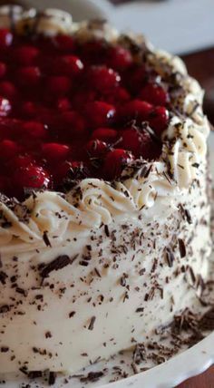 a cake with white frosting and chocolate sprinkles