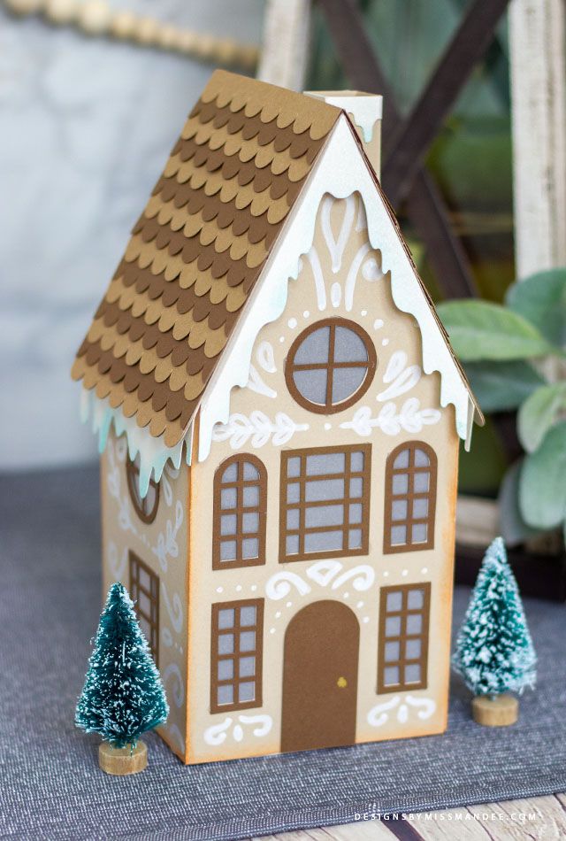 a gingerbread house with trees on the table