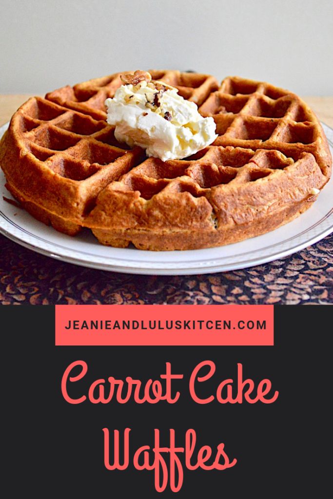 a close up of a plate of waffles with whipped cream on top and the words, carrot cake waffles