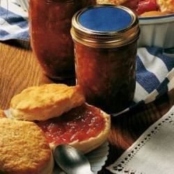 some bread and jam are on a table