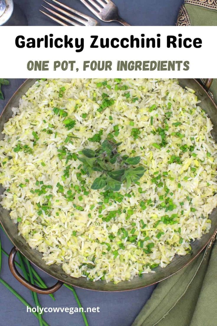 a bowl filled with rice and garnished with green herbs next to silverware