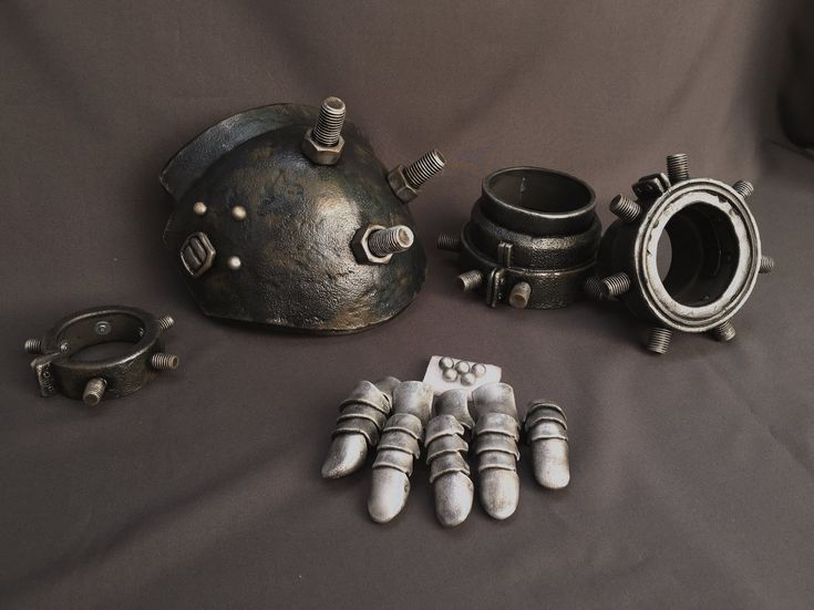 an assortment of metal objects are displayed on a table