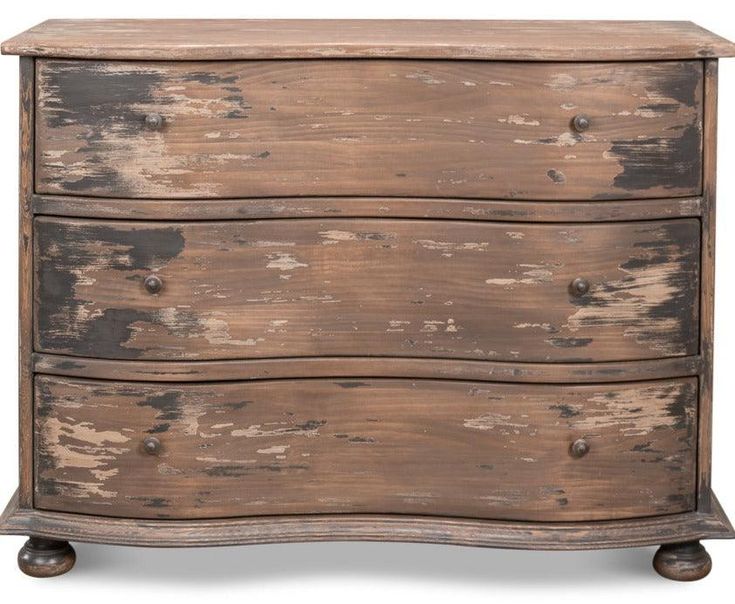 an old wooden chest of drawers with peeling paint on the top and bottom, against a white background