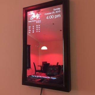 a mirror mounted to the side of a wall with a red light in front of it