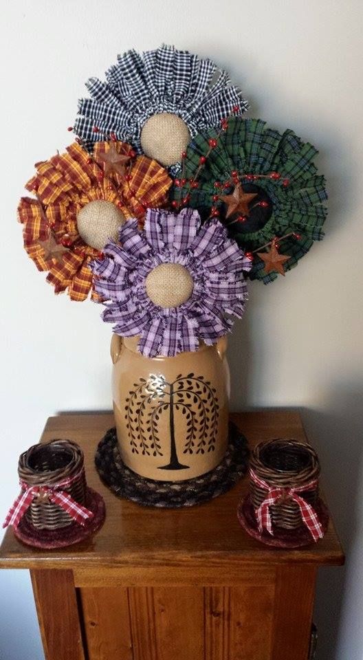 a vase filled with flowers sitting on top of a wooden table