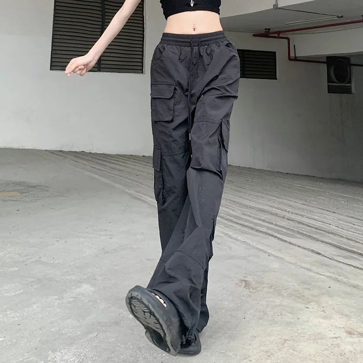 Get ready to elevate your street style with our High Waisted Utility Joggers. These joggers feature a trendy high waist and practical utility pockets, perfect for carrying all your essentials. Pair with your favorite sneakers for a comfortable and stylish look. (But don't worry, you won't actually have to jog in them.) Straight Leg Parachute Pants For Sports, Sports Parachute Pants With Pockets And Straight Leg, Sporty Cargo Style Sweatpants With Straight Leg, Sporty Cargo Style Straight Leg Sweatpants, Wide Leg Cargo Joggers For Streetwear, Sporty Baggy Parachute Pants With Hip Pockets, Functional Cargo Jeans For Streetwear, Trendy Sports Pants With Pockets, Baggy Straight Leg Joggers With Cargo Pockets