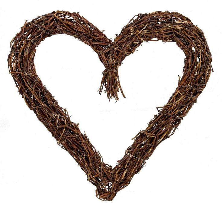 a heart made out of twigs on a white background