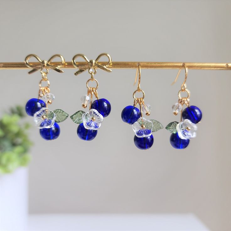 Our sweet blueberry cluster earrings are made with glass berries, glass flowers, crystal beads and 14K gold plated earring hooks which are great for delicate ears. It comes with beautiful eco-friendly wrapping, makes for a great gift. We also have silver version available. Please contact us for details!Size: The long version (W x L) is about 1.5 cm x 3.2 cm The short version (W x L) is about 1.5 cm x 2 cm Handcraft Earrings, Blueberry Festival, Blueberry Earrings, Fruit Blueberry, Wedding Fruit, Short Earrings, Blueberry Fruit, Glass Fruit, Fruit Earrings