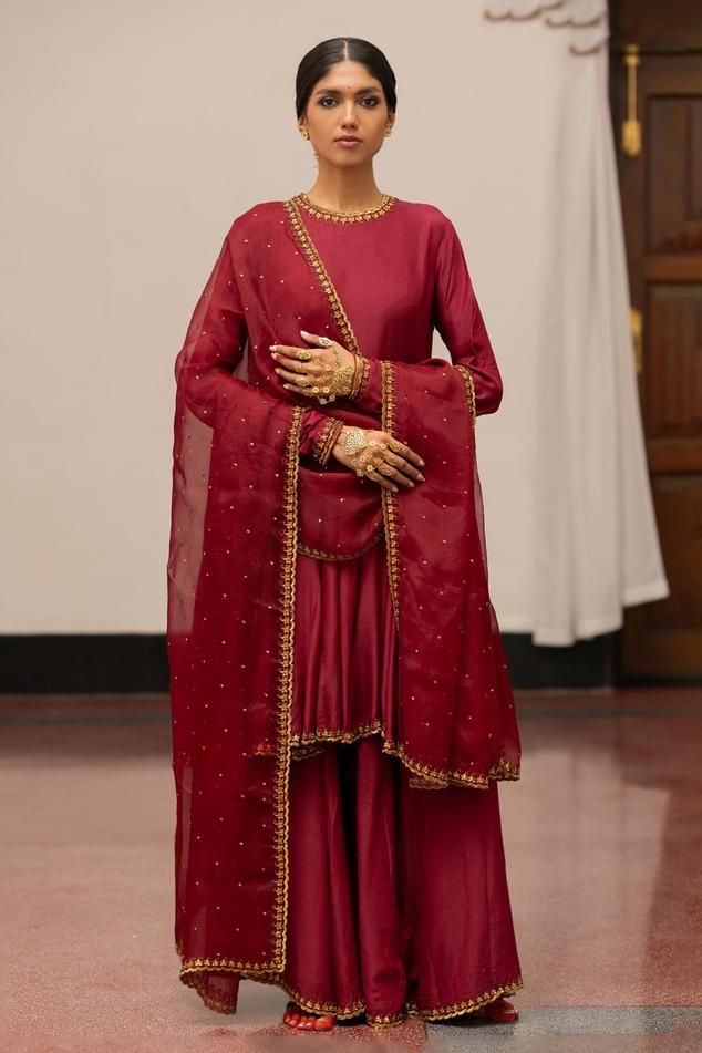 Burgundy anarkali with woven, floral sequin embroidery detailing. Paired with sharara and dupatta.
Components: 3
Pattern: Embroidered, Woven
Type Of Work: Floral
Neckline: Round
Sleeve Type: Full
Fabric: Kurta, Sharara: Munga Silk, Dupatta: Organza Silk
Color: Wine
Other Details: 
Embroidered dupatta
Model height: 5ft 7inches, wearing size S
Length: 39 inches
Occasion: Puja - Aza Fashions Semi-stitched Salwar Kameez With Dupatta For Reception, Semi-stitched Palazzo Set With Dupatta For Wedding, Raw Silk Anarkali Set With Dabka Work For Reception, Reception Dabka Work Raw Silk Anarkali Set, Anarkali Sets With Zari Work In Traditional Drape, Semi-stitched Chanderi Sharara With Dabka, Reception Anarkali Set With Dabka Work In Dola Silk, Reception Anarkali Set With Dabka Work On Dola Silk, Anarkali Cutdana Sharara For Reception