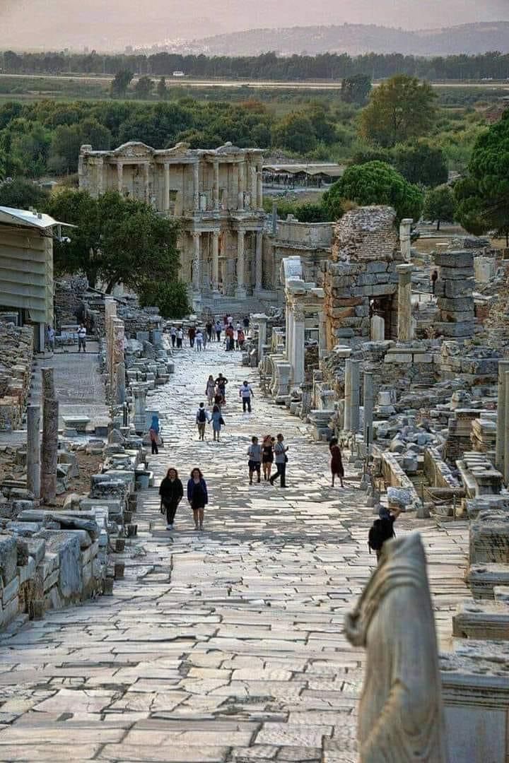 tourists walk through the ruins of ancient city ephes