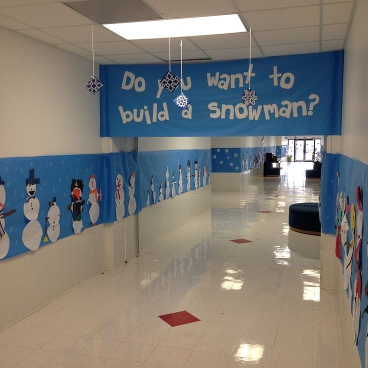 an empty hallway with snowmen painted on the walls and decorations hanging from the ceiling