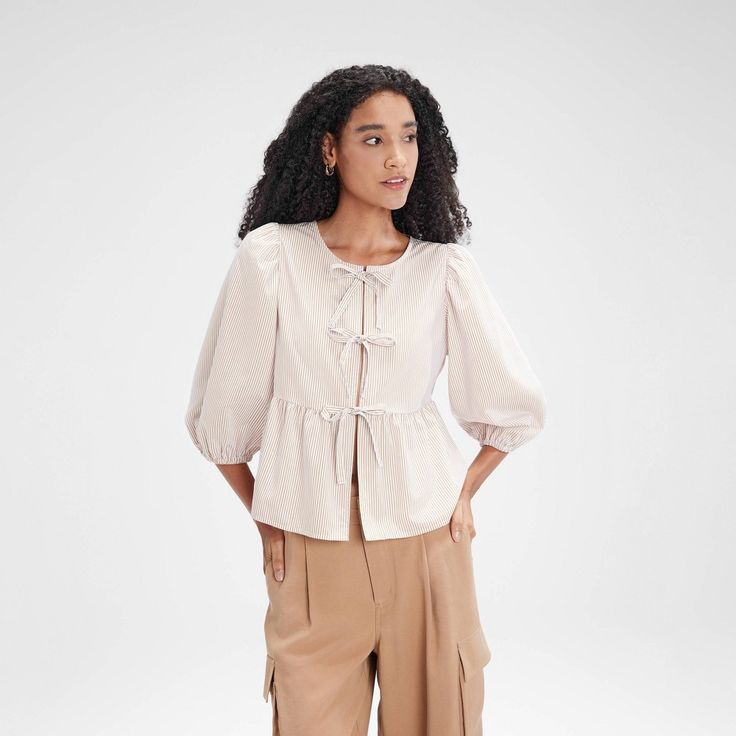 Featuring a versatile front tie that can be styled into a bow or draped for various looks, this blouse boasts mid-length puff sleeves and a flowy peplum hem for a feminine touch. Made from lightweight, soft fabric, it offers a relaxed fit that's ideal for pairing with jeans, skirts, or shorts. Perfect for any occasion, from casual outings to more polished events. A New Day™: Style that goes wherever you do. Causal Outfits, Tie Design, Tie Front Blouse, Peplum Hem, Womens Tie, Flowy Tops, Striped Blouse, A New Day, Denim Top