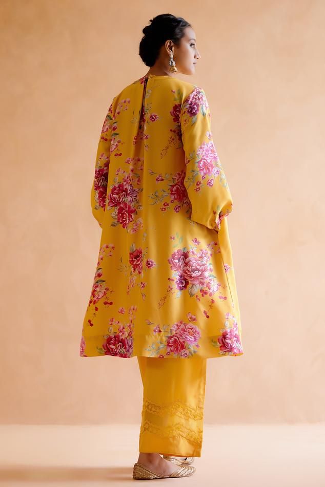 Yellow silk kurta featuring digitally printed florals with pleating details at the front and back. Paired with a hand embroidered tonal pant in pure silk.
Components: 2
Pattern: Printed
Type Of Work: Floral
Neckline: Round
Sleeve Type: Pleated
Fabric: Silk
Color: Yellow
Other Details: 
Kaftan length: 42 inches
Model Height: 5ft 9inches, wearing size S
Occasion: Mehendi and Haldi - Aza Fashions Silk Kurta, Yellow Silk, Pleated Fabric, Fabric Silk, Pant Set, Set For Women, Aza Fashion, Model Height, Pure Silk