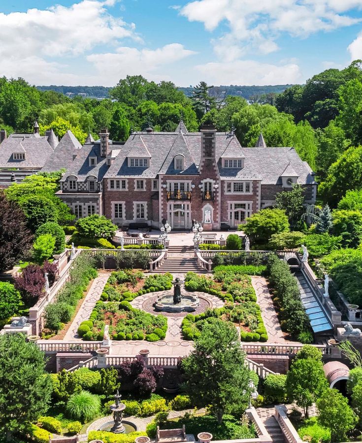 an aerial view of a large mansion surrounded by trees