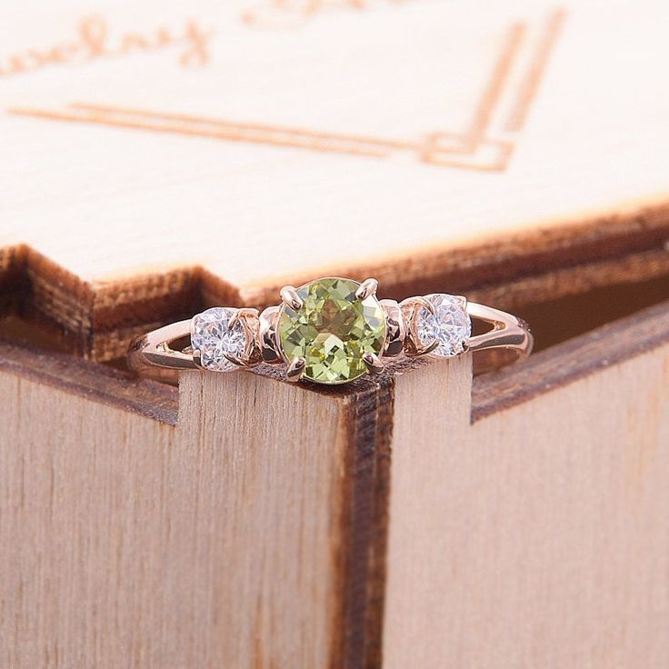 "Simple & dainty 14k rose gold peridot promise ring for her, Elegant 3 stone womens promise ring, Gold 3 stone peridot engagement ring WE OFFER UNLIMITED PERIOD INSTALLMENTS PLAN This is a beautiful, stunning, feminine ring that works well for all occasions, styles, and ages. You will love it! Ring information Main stone: Peridot Approximate size: 4.5mm Accent stone: Cubic zirconia Approximate size: 3mm Metal type: Gold Metal stamp: 14k solid gold Customization / Replacements It's easy to cr Dainty Peridot Birthstone Ring For Wedding, Green Three Stone Peridot Jewelry, Green Peridot Three Stone Jewelry, Dainty Peridot Promise Ring, Three Stone Peridot Ring Jewelry, Elegant Three Stone Peridot Ring, Three Stone Peridot Ring, Elegant Peridot Promise Ring, Peridot Three Stone Ring