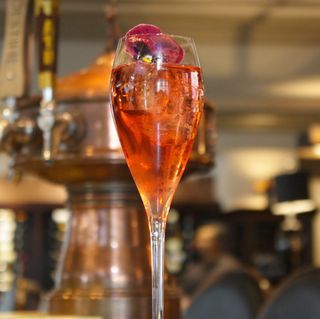 a glass filled with liquid sitting on top of a table