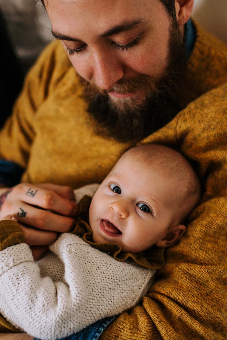 a man holding a baby in his arms