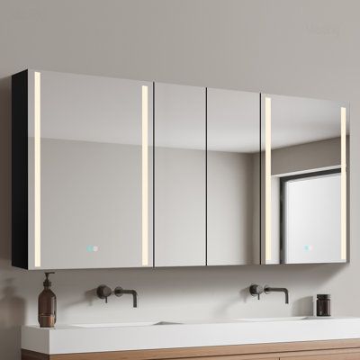 a bathroom vanity with two sinks and mirrors