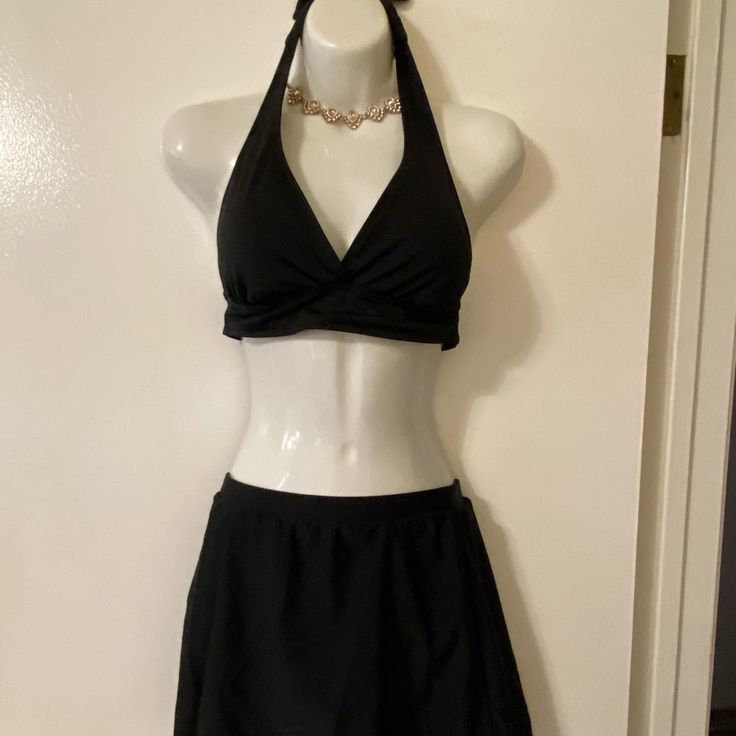 Black Halter Swim Top With Sewn In Pads By Catalina. Ties Around Neck And Back. Size M (8-10). Tried On But Never Worn In Water. Unbranded Black Swim Skirt - Never Worn. Elastic Waist Measures 12 1/2”. Full Coverage Lined Bottoms. Black Swim Dress With Built-in Bra For Beach Season, Black V-neck Lined Swimwear, Black Lined V-neck Swimwear, Black Swimwear With Built-in Bra For Spring, Chic Black Tankini With Built-in Bra, Elegant Stretch Halter Top For Pool, Elegant Halter Top For Poolside, Elegant Fitted Halter Top For Poolside, Fitted Black Swimwear For Beachwear