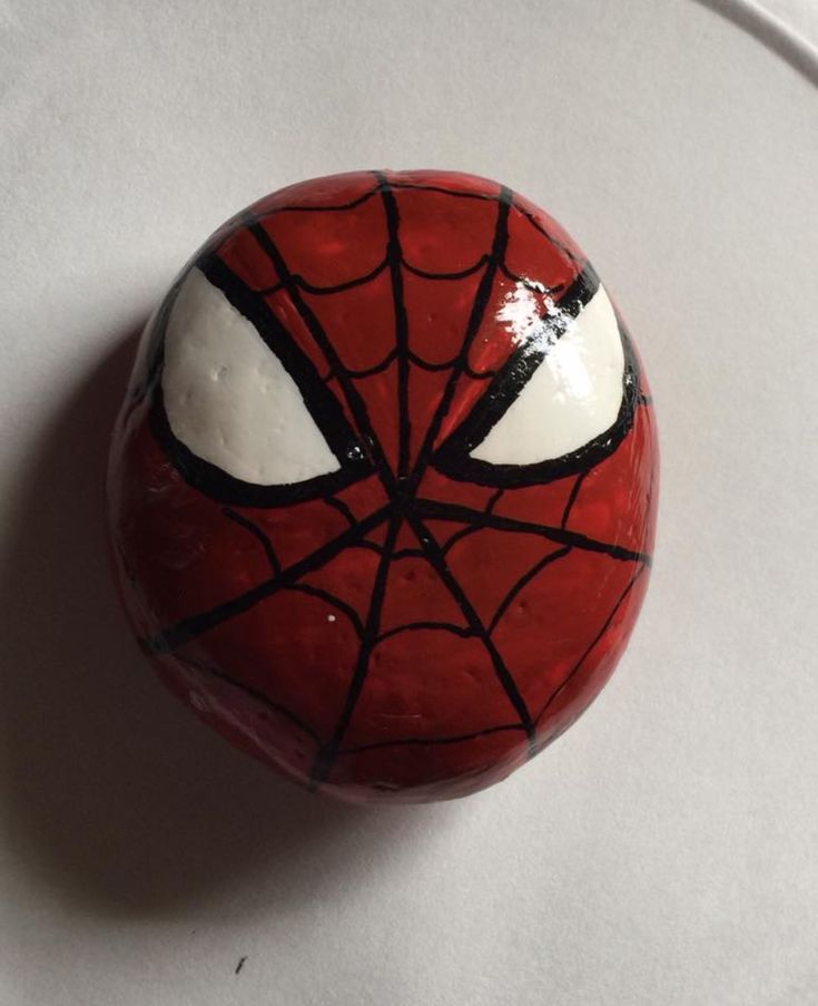 a close up of a ball with a spiderman face painted on it