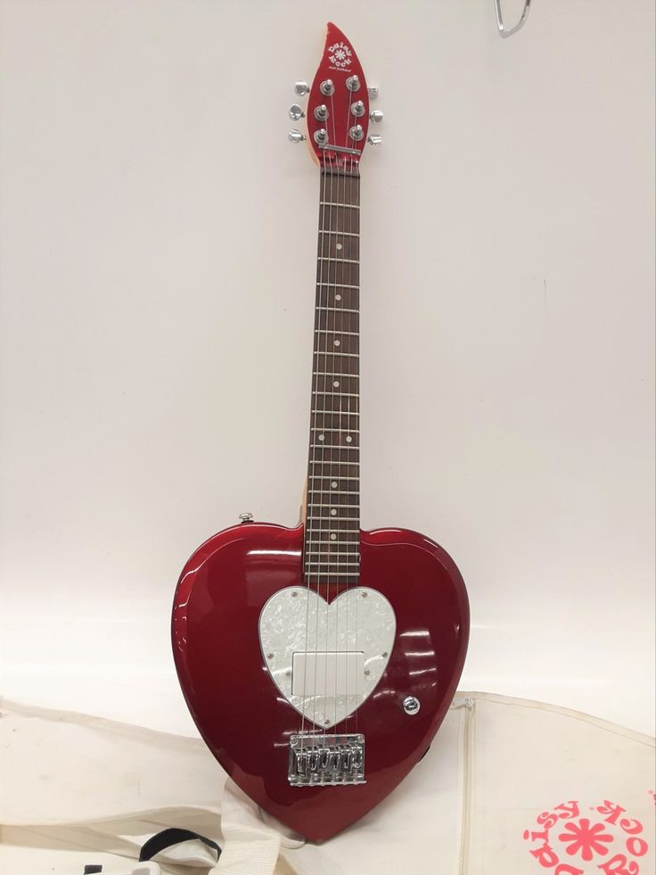 a red guitar with a white heart on it